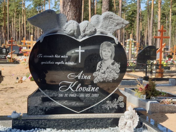 Granite gravestone in the shape of a heart with angels